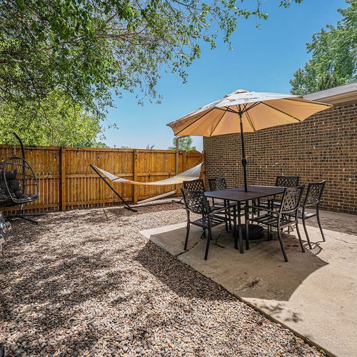 - relax in the hammock or gather for meals at the shaded dining table
- spacious fenced yard with trees provides both sun and cool retreat
- great for lounging grilling and spending quality time outdoors with friends