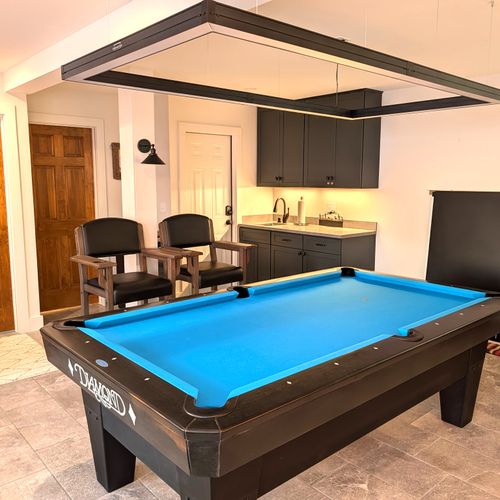 GAME ROOM (LOWER LEVEL):  The home has an incredible game room on the lower level with a championship pool table and large screen television.