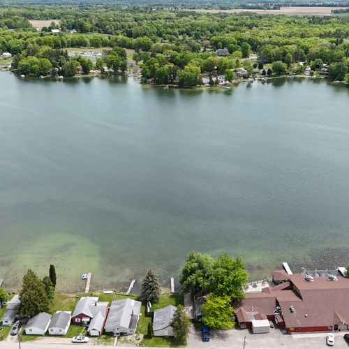 Overall:  a broad view of turk lake with the cottage and restaurant in front of the lake