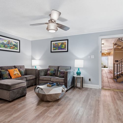 Airy open living space w/ ceiling fan & a smart, welcoming layout.