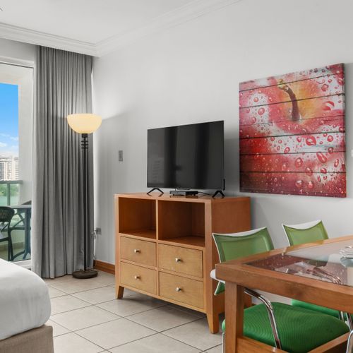 Relax and unwind in this bright studio, where the inviting bed faces large doors opening to an incredible view.