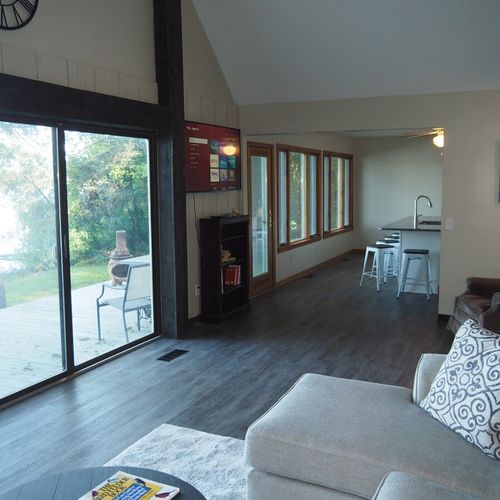Overview:  the living room features great natural lighting and gorgeous views of bass lake!