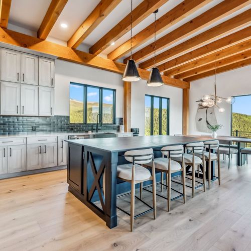 Chic dining area with seating for eight and mountain views.