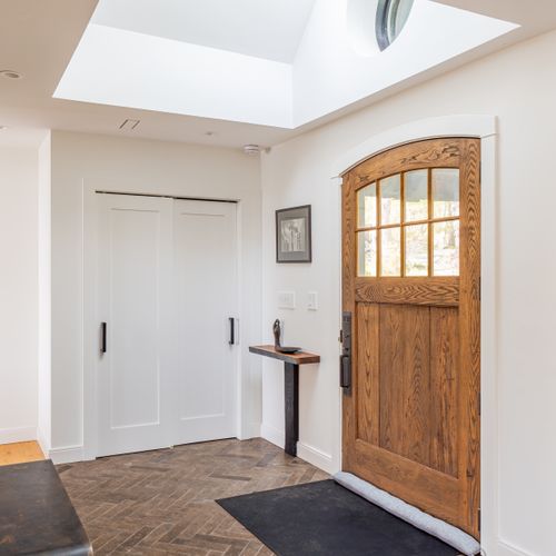 Step inside the foyer, with oversized solid wood door and skylight. The heart of the home is straight ahead, a massive fireplace covered in natural stone from the surrounding area.