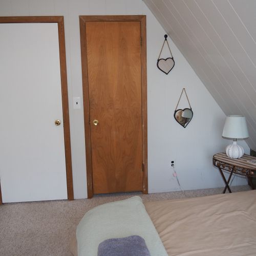 Bedroom #2 (second floor):  features a queen-size bed, walk-out balcony with lakeview, nightstands with lamps, ceiling fan, and a closet.