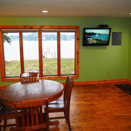 Living room and dining area:  very cute and cozy living room and dining area with a sofa, comfy chairs, dining table and chairs for 4 adults, ceiling fan, television with satellite tv, and a great view of turk lake!