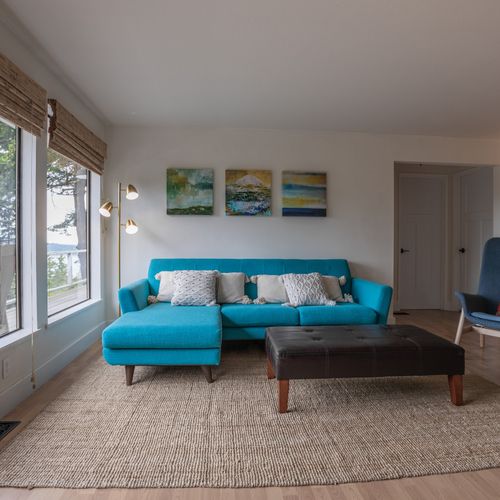 Large windows overlooking the water and trees.