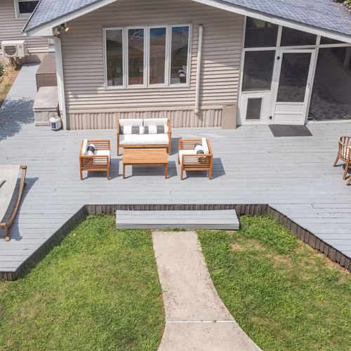 A spacious back deck overlooking the in-ground pool, perfectly designed for those who enjoy grilling, sunbathing, and lounging outdoors.