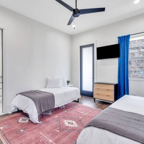 Another angle of the twin-bed upstairs room — spacious & full of natural light.