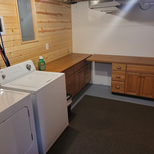 Laundry room:  there is a large laundry room in the basement that includes a washer, dryer, folding area, iron, and ironing board.