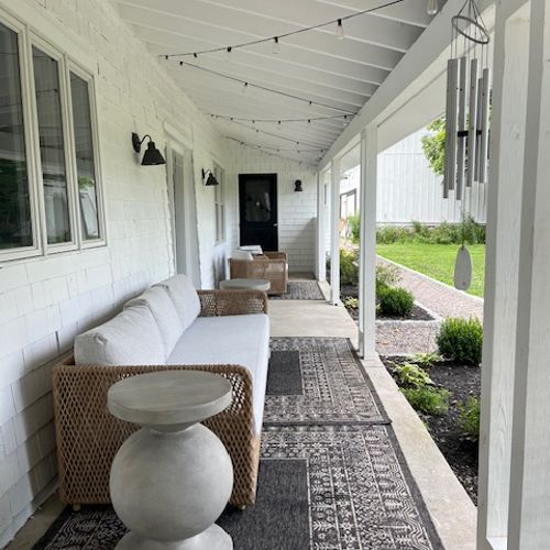 A charming porch with ample seating is ideal for letting the long hours roll by.