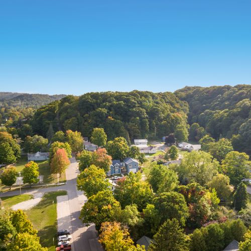 EXTERIOR:  Aerial view of the home with the dunes of Elberta in the background.