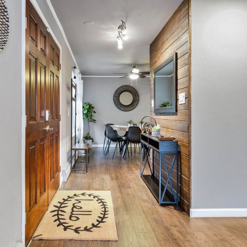 The open hallway connects the living space with the dining area for ease of access.