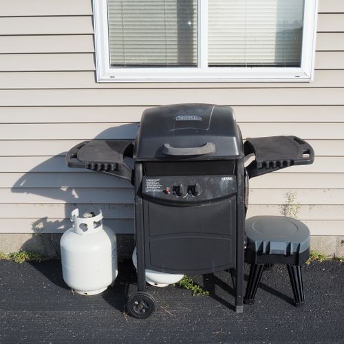 Exterior:  the propane grill that is next to the garage.