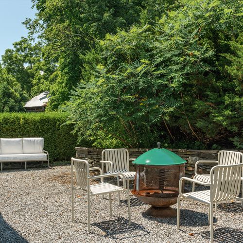 Relax by the fire pit on the patio, just off the back of the house.