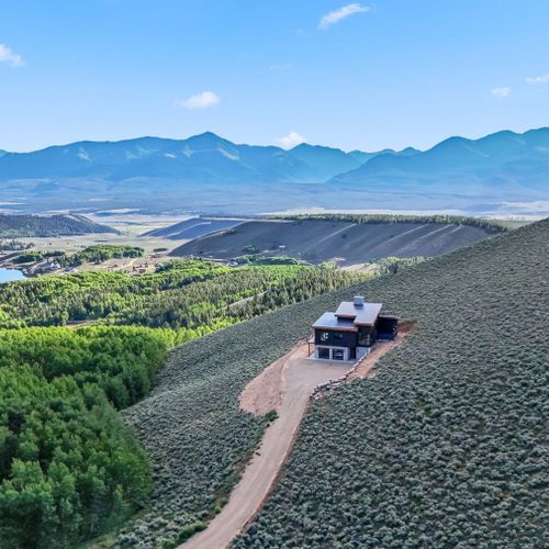 Modern mountain home surrounded by expansive acreage and natural beauty.