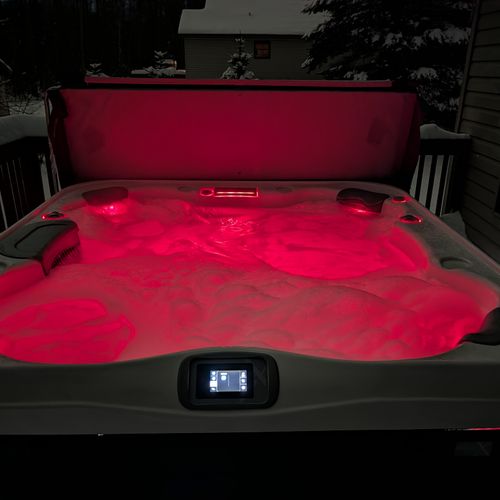 EXTERIOR:  One of the various different colors that can be selected for the hot tub at night.