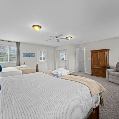 Bright bedroom with seating area and plenty of space