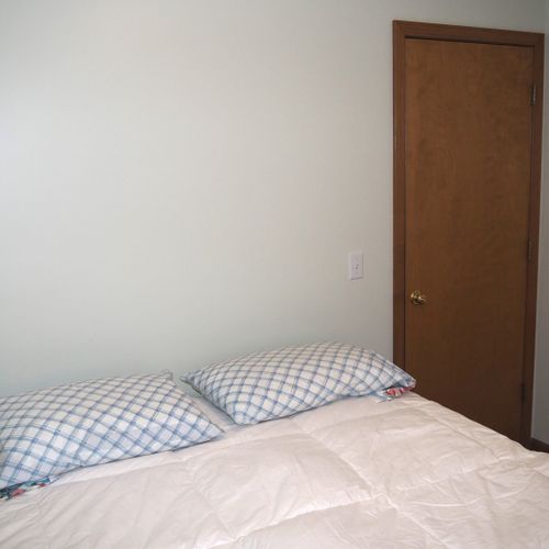 Bedroom #1 (main floor):  features a queen-size bed and a dresser.