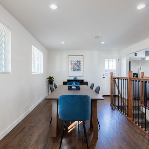 The dining table is fitted with a mid-mod table, plush velvet chairs and seats 6 comfortably.