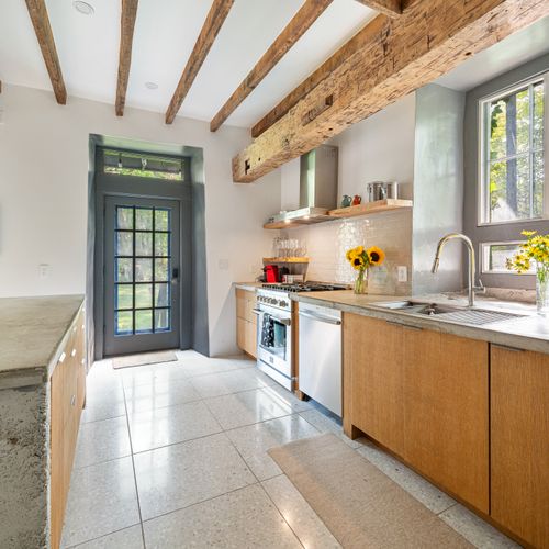 Exposed beams in the kitchen underscore the long history behind this exquisite property.