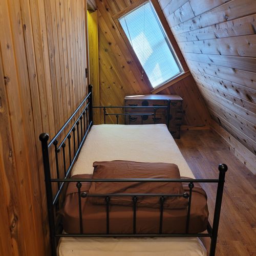 Bedroom #3 (no door / open to stairwell):  large upstairs loft bedroom features a queen-size bed and a trundle bed (i. E. A twin bed with a twin bed below it). Also has its own a/c unit.