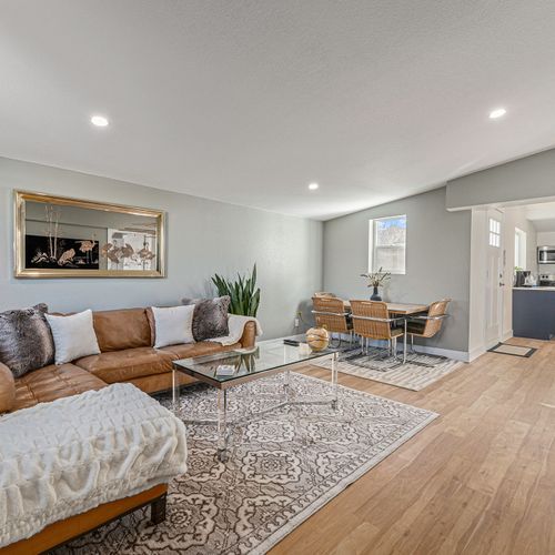 - stretch out on the cozy leather sectional for movie nights or lazy mornings
- share meals and laughs around the stylish woven dining chairs and sleek table
- flow easily from living to kitchen in this bright, open concept layout