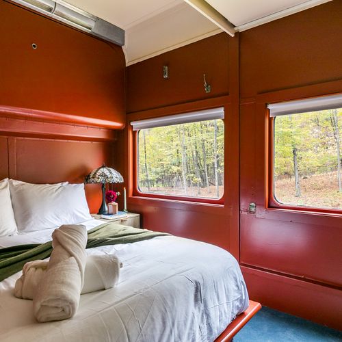 The Empire Suite equipped with a closet, bedside table, robes and slippers.