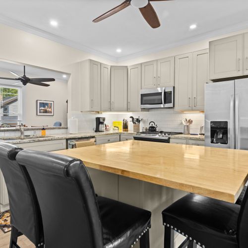 KITCHEN:  The home has a newly-renovated kitchen with a large kitchen island and all appliances, including a dishwasher.  There is also a good supply of cooking and dining utensils provided.
