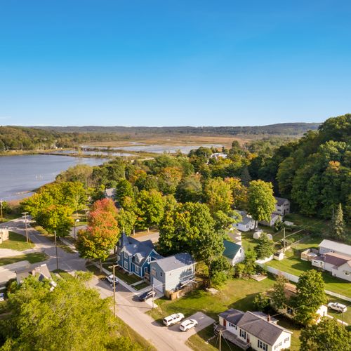 OVERVIEW:  Aerial view of the home with Betsie Bay, the Betsie River, and the dunes of Elberta in the background.