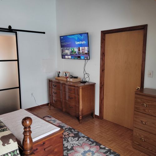Bedroom #2 (second floor):  very large bedroom features a queen-size bed, walk-out deck, chair, 2 nightstands, 2 lamps, 2 dressers, ceiling fan, television, and private en suite full bathroom