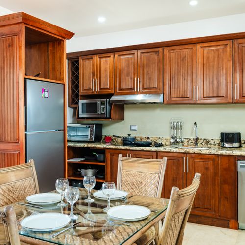 Kitchenette with induction stove, minibar fridge, microwave and dishwasher