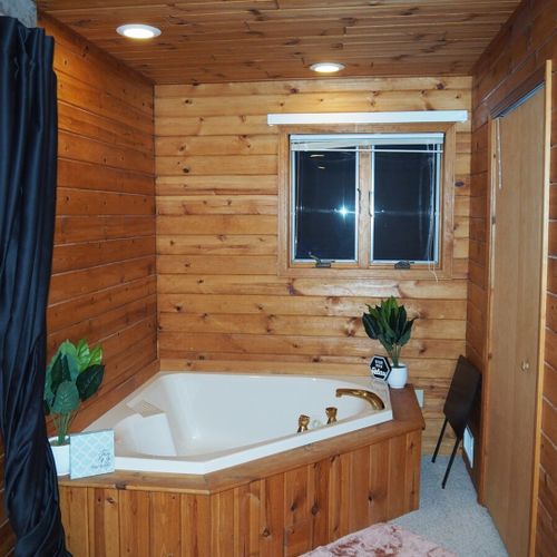 Bedroom #2 (second floor):  this is a huge upstairs bedroom with it's own television, desk, jetted tub, king-size bed, dresser, mirror, closet, and private en suite bathroom!