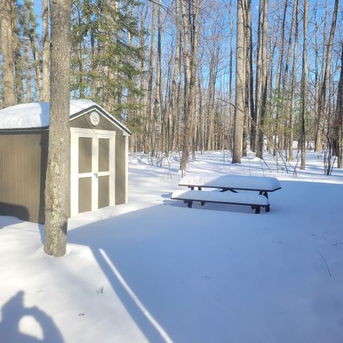 Exterior:  the backyard, highlighting the outdoor picnic table.