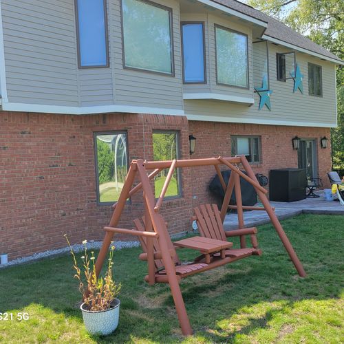 EXTERIOR:  Another view of the backyard, showing the swing, hammock, and outdoor patio.