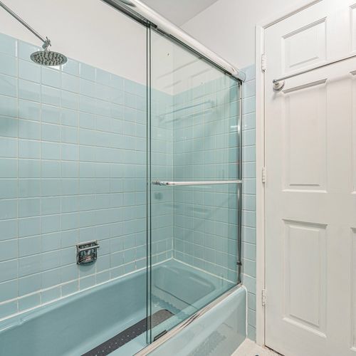 This upstairs bathroom features a convenient tub-shower combo, offering flexibility for a quick rinse or a relaxing soak, all in a clean and inviting space.