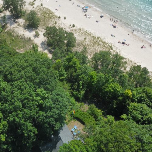 Exterior:  another aerial view showing the home (with the backyard deck visible) and looking out towards frankfort beach and lake michigan