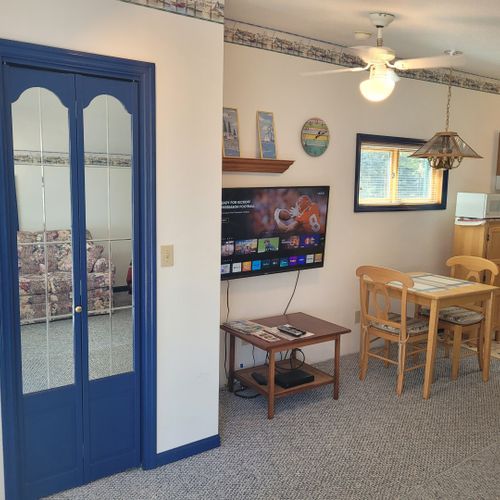 Main room:  closet, television, and dining table