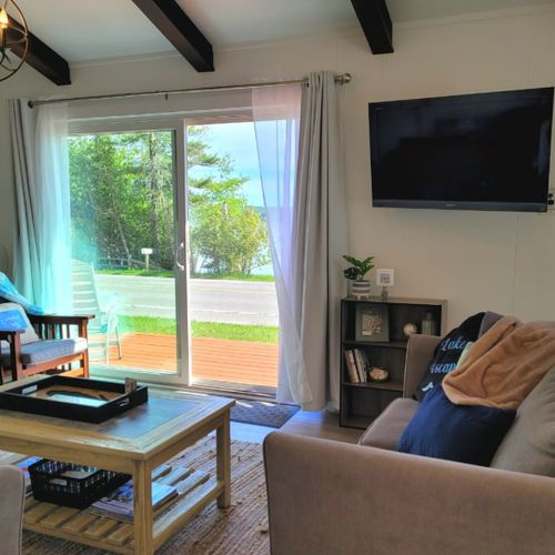 Living room:  the cottage features a very bright, modern, and fun living room with a beachy design and a wall-mounted television with live streaming via roku.