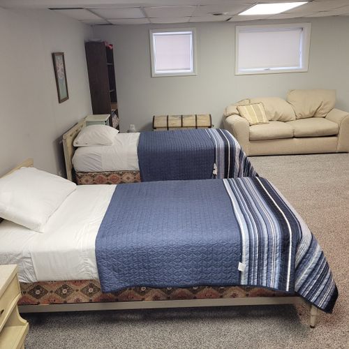 Lower level:  the lower level of the home has 2 single beds, a dresser, a sofa, half-bath, and a large laundry room.