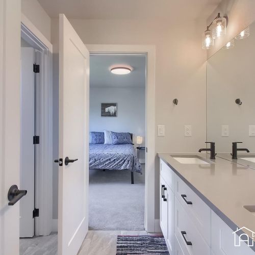The shared bathroom features extended two sink vanities to provide lots of space for your travel essentials and toiletries.