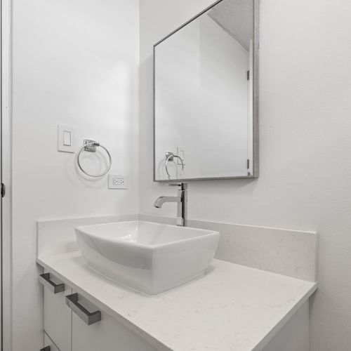 Modern bathroom with vessel sink & clean, contemporary design.