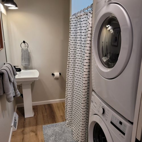 Bathroom #2:  second full bathroom that also serves as the laundry room having a stacked washer and dryer in it.