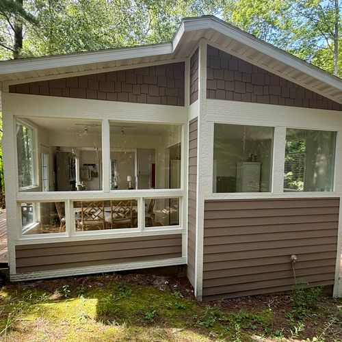 EXTERIOR:  The east side of the cabin, looking into the dining area on the left and the bedroom on the right.  (Note that there are blinds for all bedroom windows.)