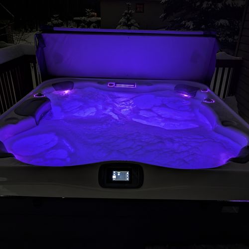EXTERIOR:  One of the various different colors that can be selected for the hot tub at night.