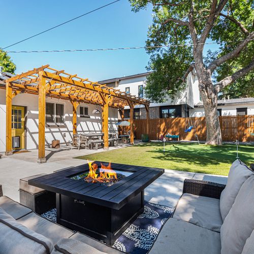 Private backyard oasis with cozy seating and lush greenery.