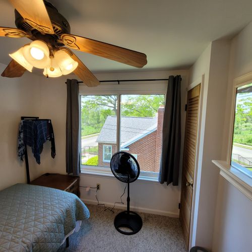 Bedroom #3 (second floor):  features a twin bed, ceiling fan, and a pedestal fan.