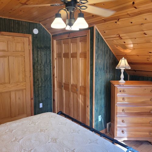Bedroom #2 (upper level):  features a queen-size bed, chair, dresser, closet, ceiling fan, nightstands, and lamp