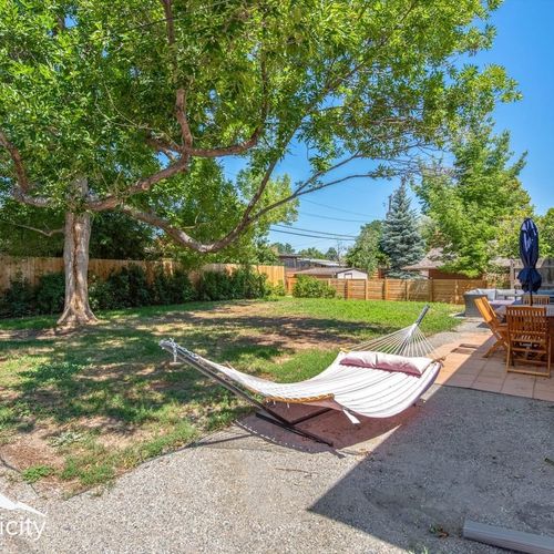 - stretch out on the shaded hammock or gather around the outdoor dining set nearby
- fenced backyard offers a peaceful space to relax, nap, or sip something cold
- towering trees, patio pavers, and privacy fencing complete your retreat