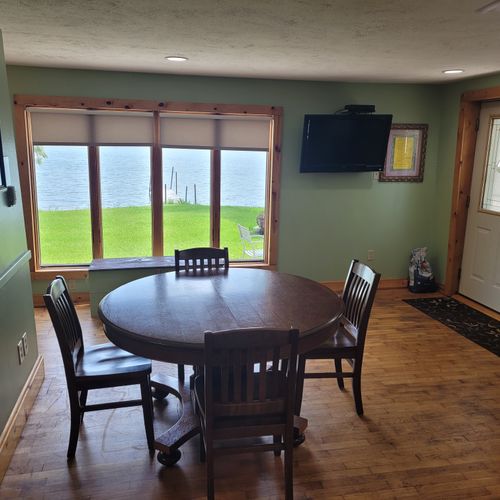 Dining room:  the dining room with the dining table and the television in the background